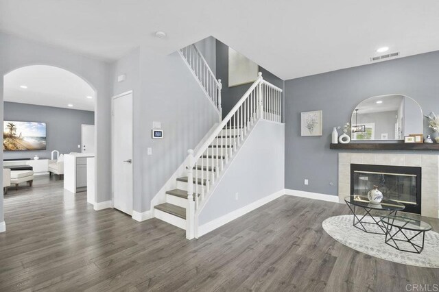 1444 Wooden Valley St, Chula Vista, CA 91913 - living area featuring wood finished floors, stairway, a fireplace, recessed lighting, and arched walkways