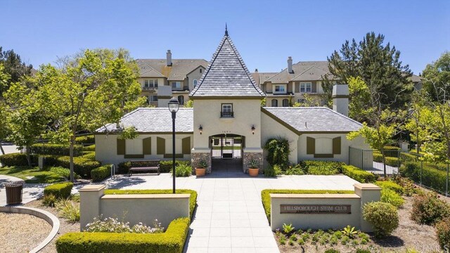 1444 Wooden Valley St, Chula Vista, CA 91913 - rear view of house with stucco siding, stone siding, and a high end roof