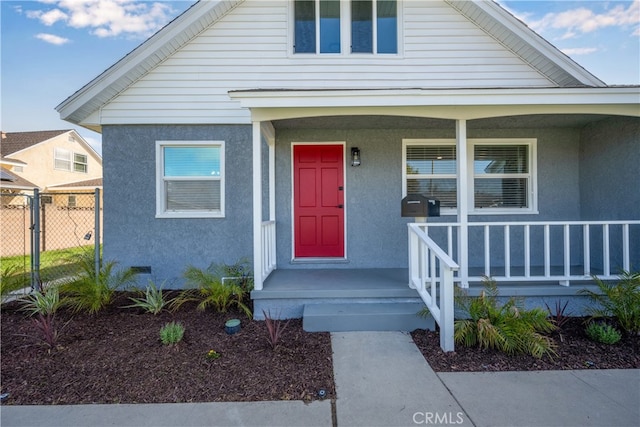 6131 Chickasaw Dr, Westminster, CA 92683 - view of front facade with covered porch, fence, and stucco siding