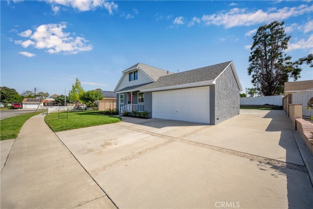 6131 Chickasaw Dr, Westminster, CA 92683 - view of front of home featuring driveway, an attached garage, covered porch, a shingled roof, and stucco siding