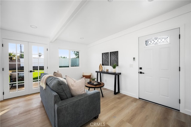 6131 Chickasaw Dr, Westminster, CA 92683 - living room with french doors, beam ceiling, light wood finished floors, and baseboards