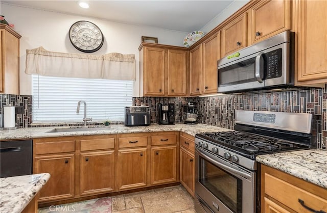 7840 La Cresta St, Highland, CA 92346 - kitchen with appliances with stainless steel finishes, a sink, brown cabinets, backsplash, and light stone countertops