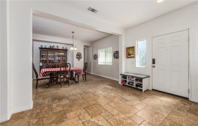 7840 La Cresta St, Highland, CA 92346 - dining area with stone tile flooring, baseboards, and a chandelier