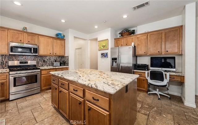 7840 La Cresta St, Highland, CA 92346 - kitchen with appliances with stainless steel finishes, tasteful backsplash, stone tile floors, a center island, and recessed lighting