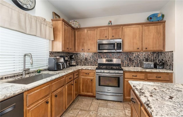 7840 La Cresta St, Highland, CA 92346 - kitchen with appliances with stainless steel finishes, a sink, decorative backsplash, and brown cabinetry