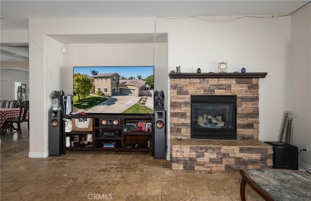 7840 La Cresta St, Highland, CA 92346 - living room with stone tile flooring, a fireplace, and baseboards