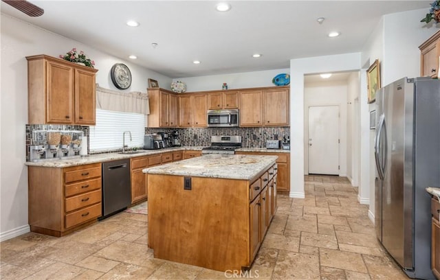 7840 La Cresta St, Highland, CA 92346 - kitchen featuring stainless steel appliances, stone tile flooring, a sink, a kitchen island, and decorative backsplash