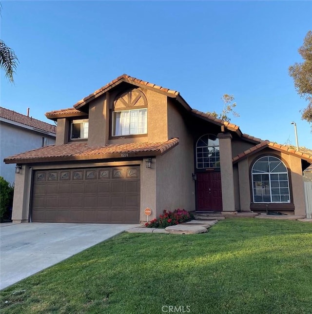 10228 Via Pavon, Moreno Valley, CA 92557 - mediterranean / spanish-style home featuring a tile roof, stucco siding, and driveway