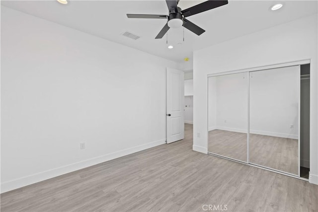 unfurnished bedroom with wood finished floors, baseboards, recessed lighting, a closet, and ceiling fan