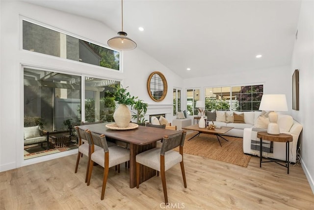 8 Galanto, Irvine, CA 92614 - dining area with high vaulted ceiling, light wood finished floors, a fireplace, recessed lighting, and baseboards