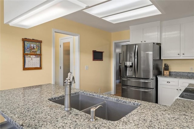 40 Gunter Ln, Oroville, CA 95966 - kitchen featuring stainless steel fridge with ice dispenser, a sink, and white cabinetry