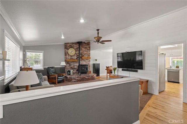 40 Gunter Ln, Oroville, CA 95966 - living area featuring ornamental molding, a wood stove, light wood-style flooring, lofted ceiling, and ceiling fan