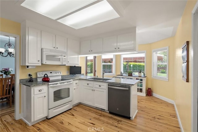 40 Gunter Ln, Oroville, CA 95966 - kitchen featuring white appliances, a sink, white cabinets, and healthy amount of natural light
