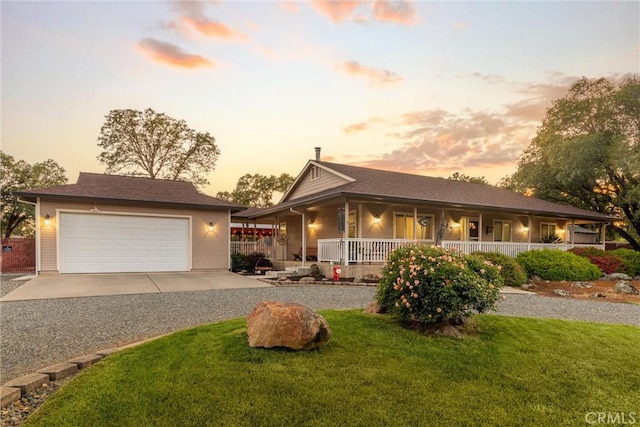 40 Gunter Ln, Oroville, CA 95966 - view of front of home featuring a porch, a garage, gravel driveway, and a front yard