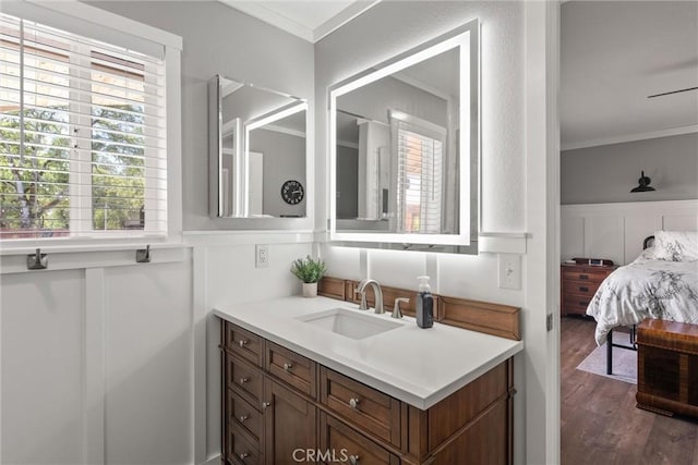 40 Gunter Ln, Oroville, CA 95966 - bathroom featuring vanity, crown molding, a decorative wall, wood finished floors, and wainscoting