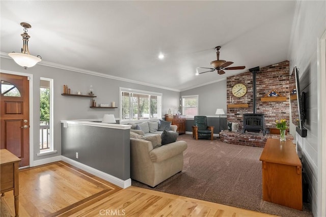 40 Gunter Ln, Oroville, CA 95966 - living area with a ceiling fan, a wood stove, wood finished floors, ornamental molding, and vaulted ceiling