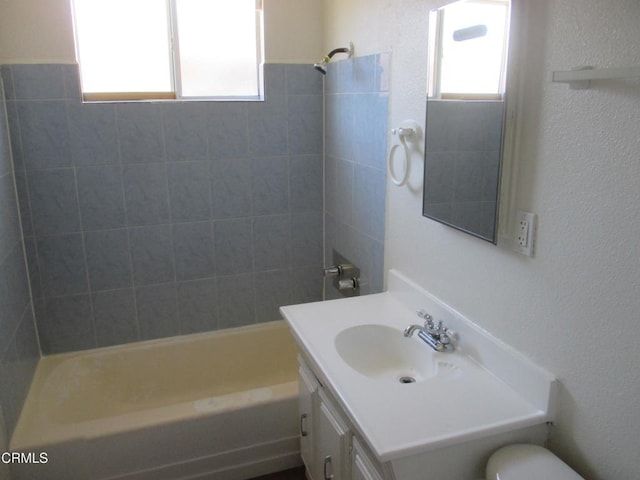 44104 Carolside Ave, Lancaster, CA 93535 - full bath featuring vanity, washtub / shower combination, and a textured wall