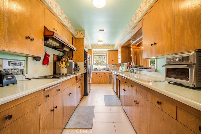 6616 Langdon Ave, Van Nuys, CA 91406 - kitchen featuring appliances with stainless steel finishes, extractor fan, light countertops, a sink, and light tile patterned floors