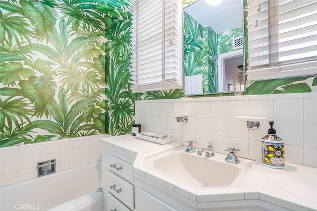 6616 Langdon Ave, Van Nuys, CA 91406 - bathroom featuring wallpapered walls, a garden tub, decorative backsplash, healthy amount of natural light, and vanity