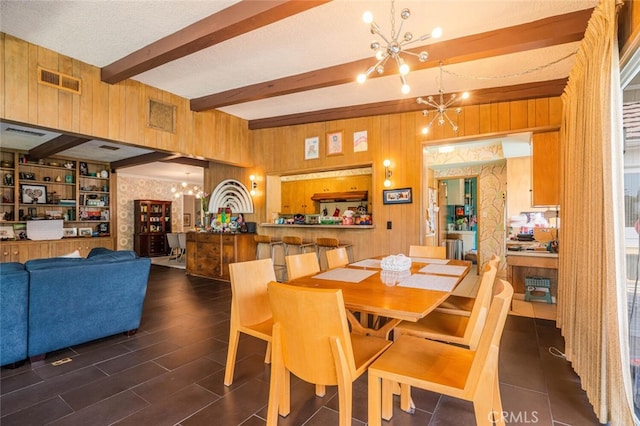 6616 Langdon Ave, Van Nuys, CA 91406 - dining room with a chandelier, beam ceiling, wood walls, and a textured ceiling