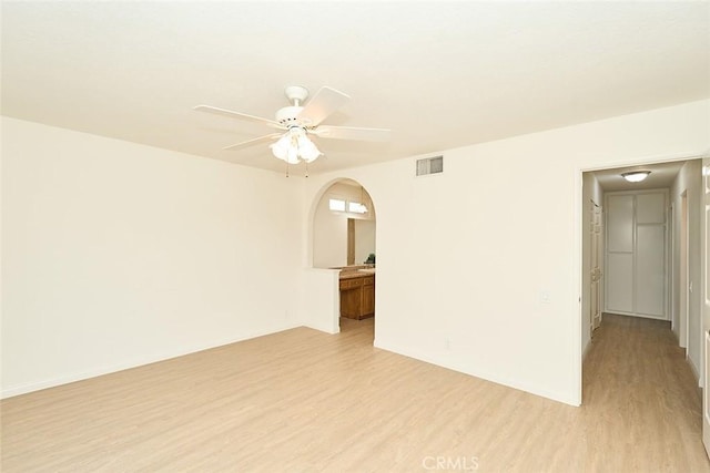 8068 Catherine Ave Unit 9, Stanton, CA 90680 - empty room featuring light wood-type flooring, ceiling fan, and arched walkways