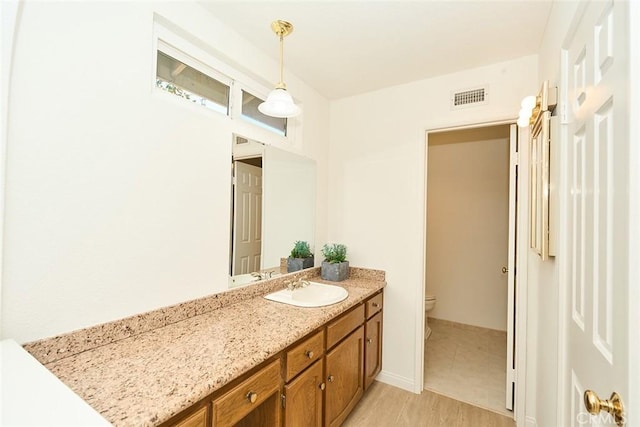 8068 Catherine Ave Unit 9, Stanton, CA 90680 - bathroom featuring toilet, vanity, and wood finished floors