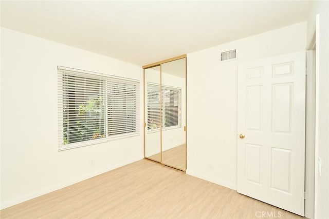 8068 Catherine Ave Unit 9, Stanton, CA 90680 - unfurnished bedroom with light wood-style floors, a closet, and baseboards