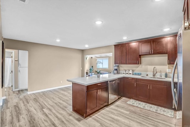 7977 Pala St, San Diego, CA 92114 - kitchen with stainless steel appliances, light wood-style flooring, light countertops, a peninsula, and recessed lighting