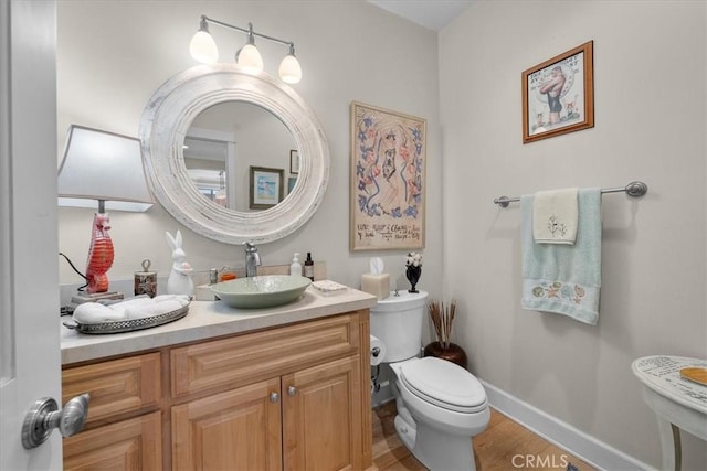 1304 Harkness St, Manhattan Beach, CA 90266 - bathroom featuring toilet, baseboards, wood finished floors, and vanity
