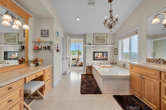 1304 Harkness St, Manhattan Beach, CA 90266 - full bath with a tile fireplace, tile patterned floors, vaulted ceiling, a bath, and vanity