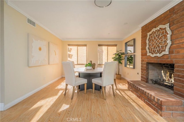 9403 Mesa Robles Dr, Whittier, CA 90603 - dining room with baseboards, light wood-style floors, crown molding, and a fireplace