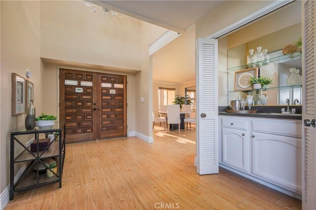 9403 Mesa Robles Dr, Whittier, CA 90603 - entrance foyer featuring light wood finished floors, a bar, and baseboards