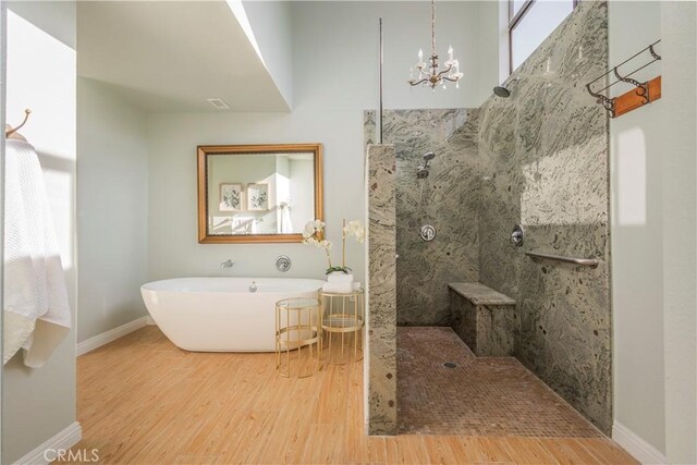 9403 Mesa Robles Dr, Whittier, CA 90603 - full bath featuring wood finished floors, a soaking tub, baseboards, walk in shower, and a chandelier
