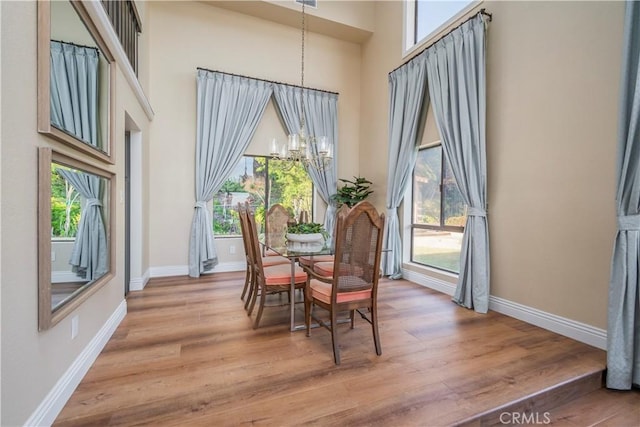 9403 Mesa Robles Dr, Whittier, CA 90603 - dining room with a chandelier, plenty of natural light, a high ceiling, and light wood finished floors