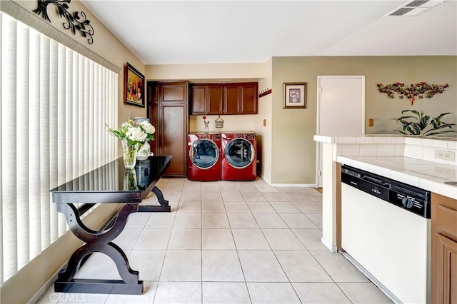 7226 Jordan Ave Unit 6, Canoga Park, CA 91303 - clothes washing area with washer and clothes dryer, light tile patterned floors, and baseboards