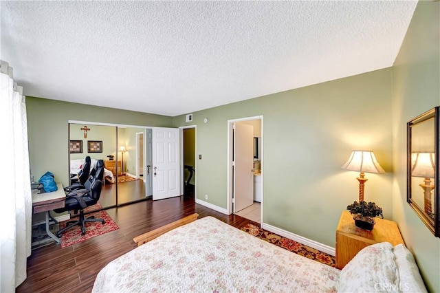 7226 Jordan Ave Unit 6, Canoga Park, CA 91303 - bedroom with a textured ceiling, a desk, wood finished floors, baseboards, and ensuite bath