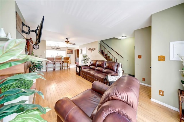7226 Jordan Ave Unit 6, Canoga Park, CA 91303 - living room featuring stairway, light wood-style floors, ceiling fan, and baseboards