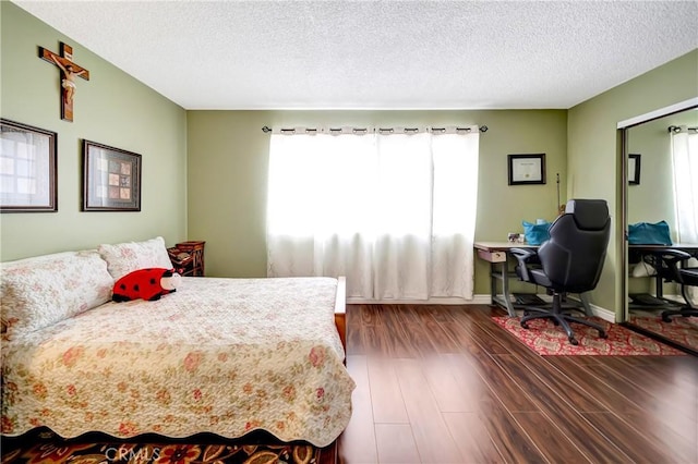 7226 Jordan Ave Unit 6, Canoga Park, CA 91303 - bedroom featuring dark wood finished floors, a textured ceiling, and a desk