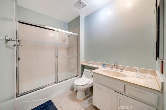 7226 Jordan Ave Unit 6, Canoga Park, CA 91303 - bathroom featuring tile patterned floors, toilet, bath / shower combo with glass door, and vanity