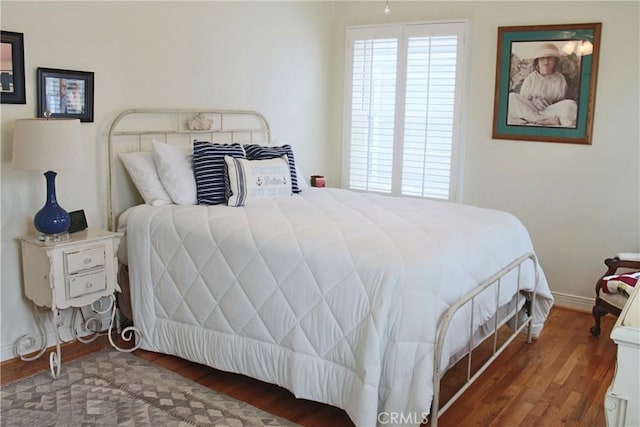 bedroom with wood finished floors and baseboards