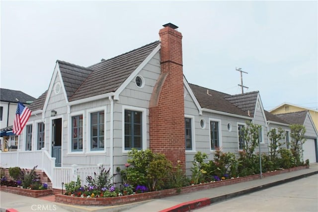 view of home's exterior with a chimney and a garage