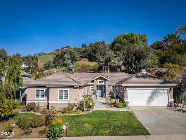 2956 Wauneta St, Newbury Park, CA 91320 - ranch-style house with stucco siding, a tile roof, concrete driveway, an attached garage, and a front yard