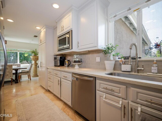 2956 Wauneta St, Newbury Park, CA 91320 - kitchen featuring stainless steel appliances, a sink, white cabinets, decorative backsplash, and recessed lighting
