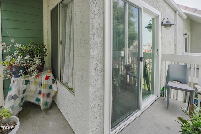 entrance to property featuring stucco siding