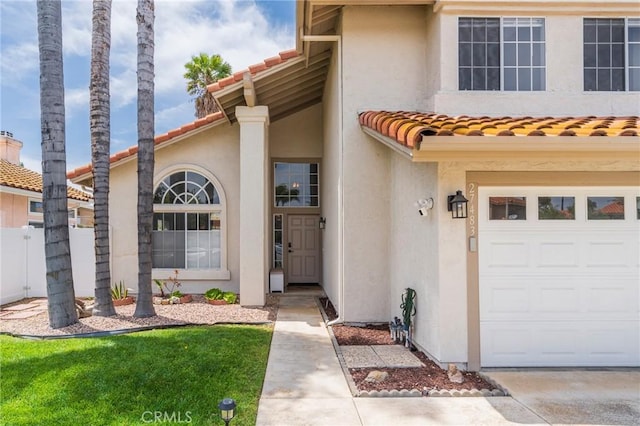 27483 Dandelion Ct, Temecula, CA 92591 - view of front facade with stucco siding, an attached garage, fence, and a tiled roof