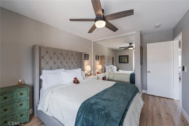 27483 Dandelion Ct, Temecula, CA 92591 - bedroom featuring light wood finished floors, a ceiling fan, a closet, and baseboards