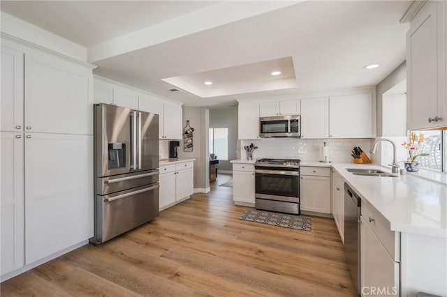 27483 Dandelion Ct, Temecula, CA 92591 - kitchen with stainless steel appliances, a sink, light wood-type flooring, tasteful backsplash, and recessed lighting