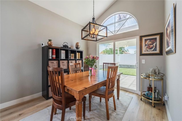 27483 Dandelion Ct, Temecula, CA 92591 - dining space with a chandelier, light wood-type flooring, baseboards, and high vaulted ceiling