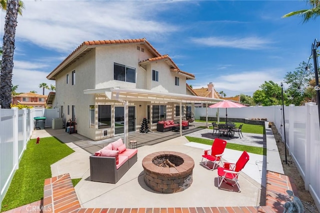 27483 Dandelion Ct, Temecula, CA 92591 - back of house featuring an outdoor living space with a fire pit, stucco siding, a tiled roof, a patio, and a fenced backyard