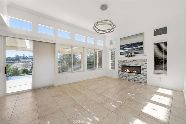 18660 Sunset Knoll Dr, Riverside, CA 92504 - unfurnished living room with tile patterned floors, a chandelier, a fireplace, and crown molding